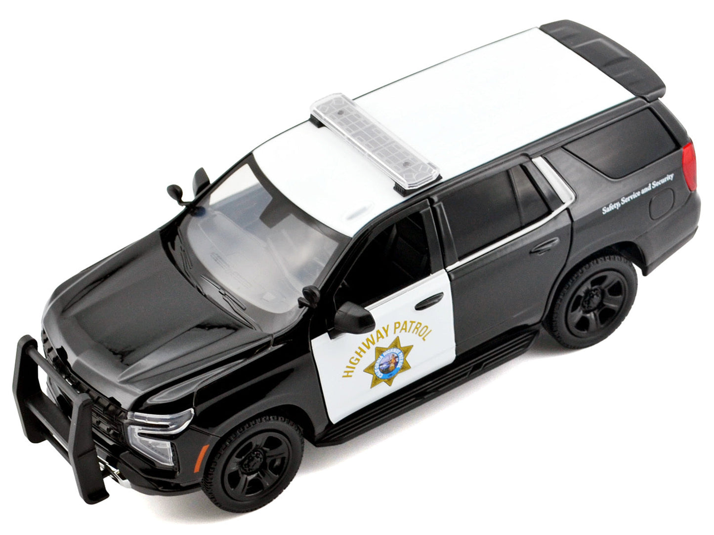 Black and white 1/24 diecast Chevrolet Tahoe police pursuit model by Motormax, featuring California Highway Patrol decals.