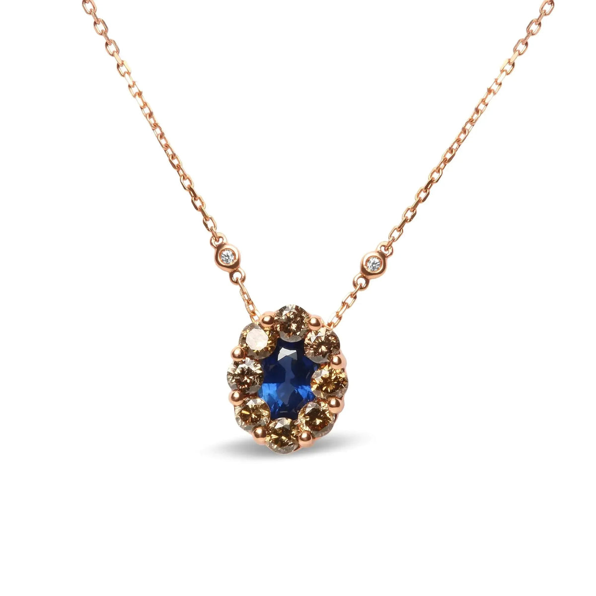 18K rose gold diamond and blue sapphire pendant necklace with oval gemstones, adjustable up to 18 inches, featuring a halo cluster design.