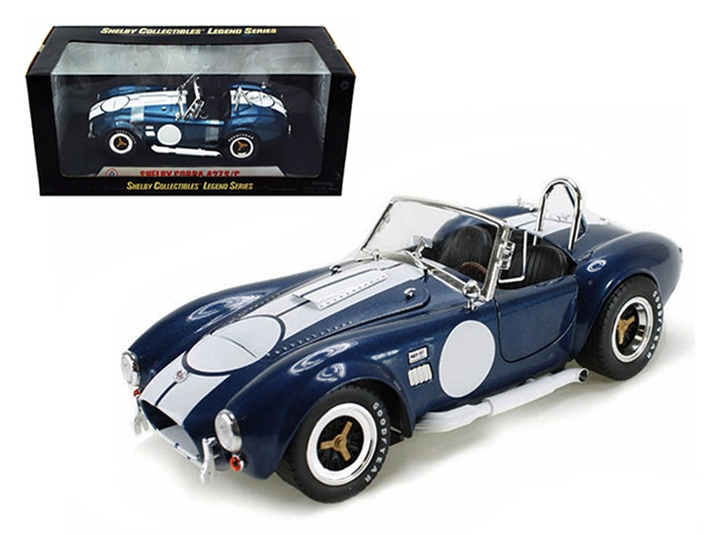 1965 Shelby Cobra 427 S/C diecast model car by Shelby Collectibles, dark blue metallic with white stripes and Carroll Shelby signature.