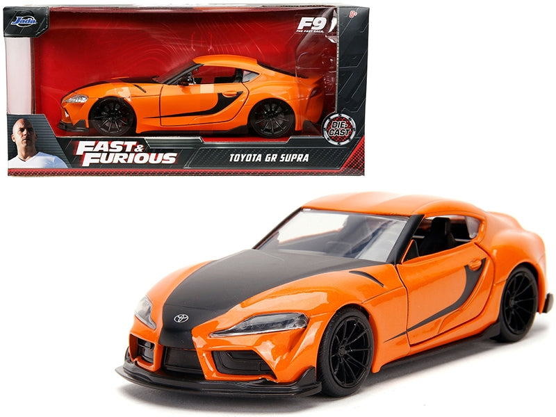 Orange Toyota GR Supra diecast model car with black stripes from Fast & Furious 9, 1/32 scale by Jada, American Smart WB.
