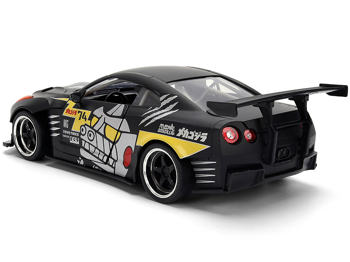 2009 Nissan GT-R R35 diecast model car by Jada in matte black with "Mechagodzilla" graphics from Hollywood Rides series, 1/24 scale.