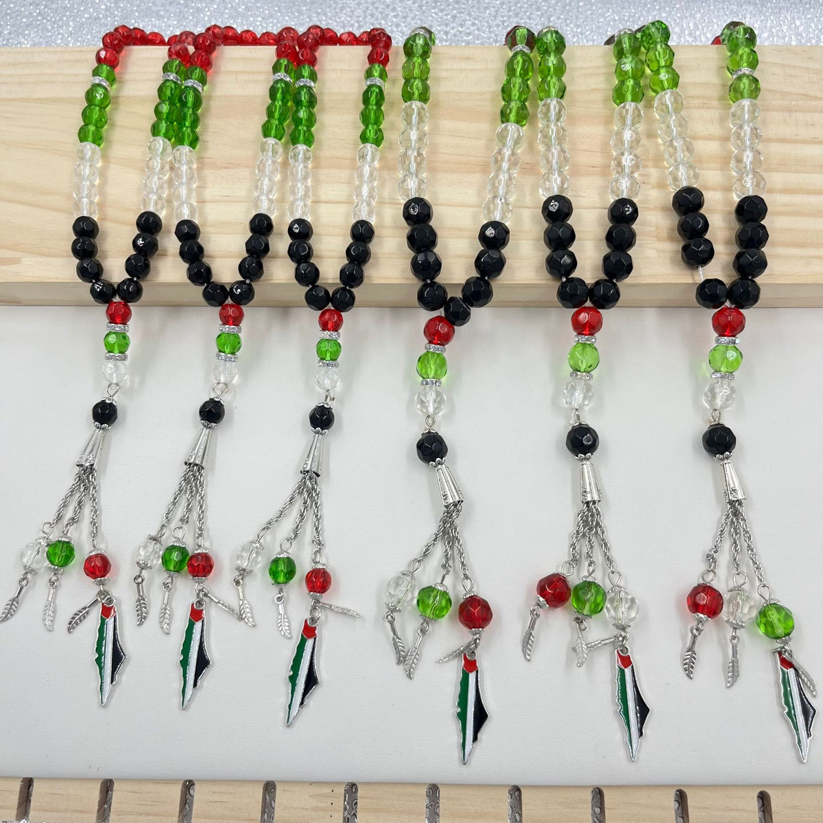 Eprolo 33 prayer beads with Palestinian flag colored crystal glass, featuring vibrant red, green, black, and white beads for spiritual use.