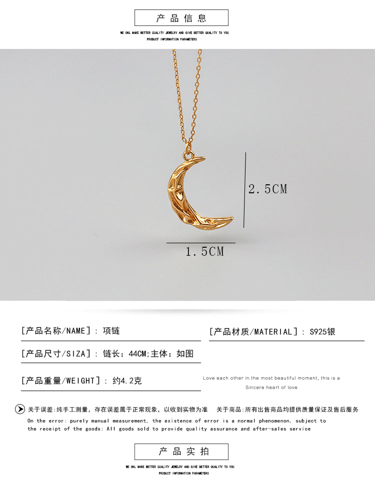 Vintage moon necklace featuring a silver pendant with celestial designs, styled with a delicate chain.