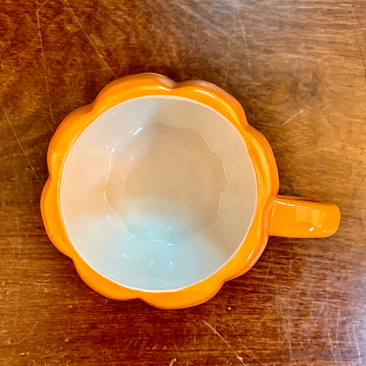 ClaudiaG Home ceramic Halloween pumpkin mug with orange and black design, perfect for festive hot beverages.