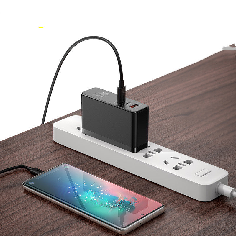 American Smart Mini Fast Charger for notebooks, compact charger with USB-C port, black plastic body, and power indicator light.