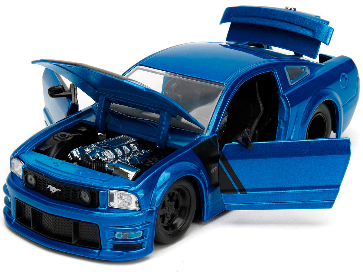 2006 Ford Mustang GT blue metallic diecast model car by Jada, featuring matte black hood and stripes, Bigtime Muscle Series.