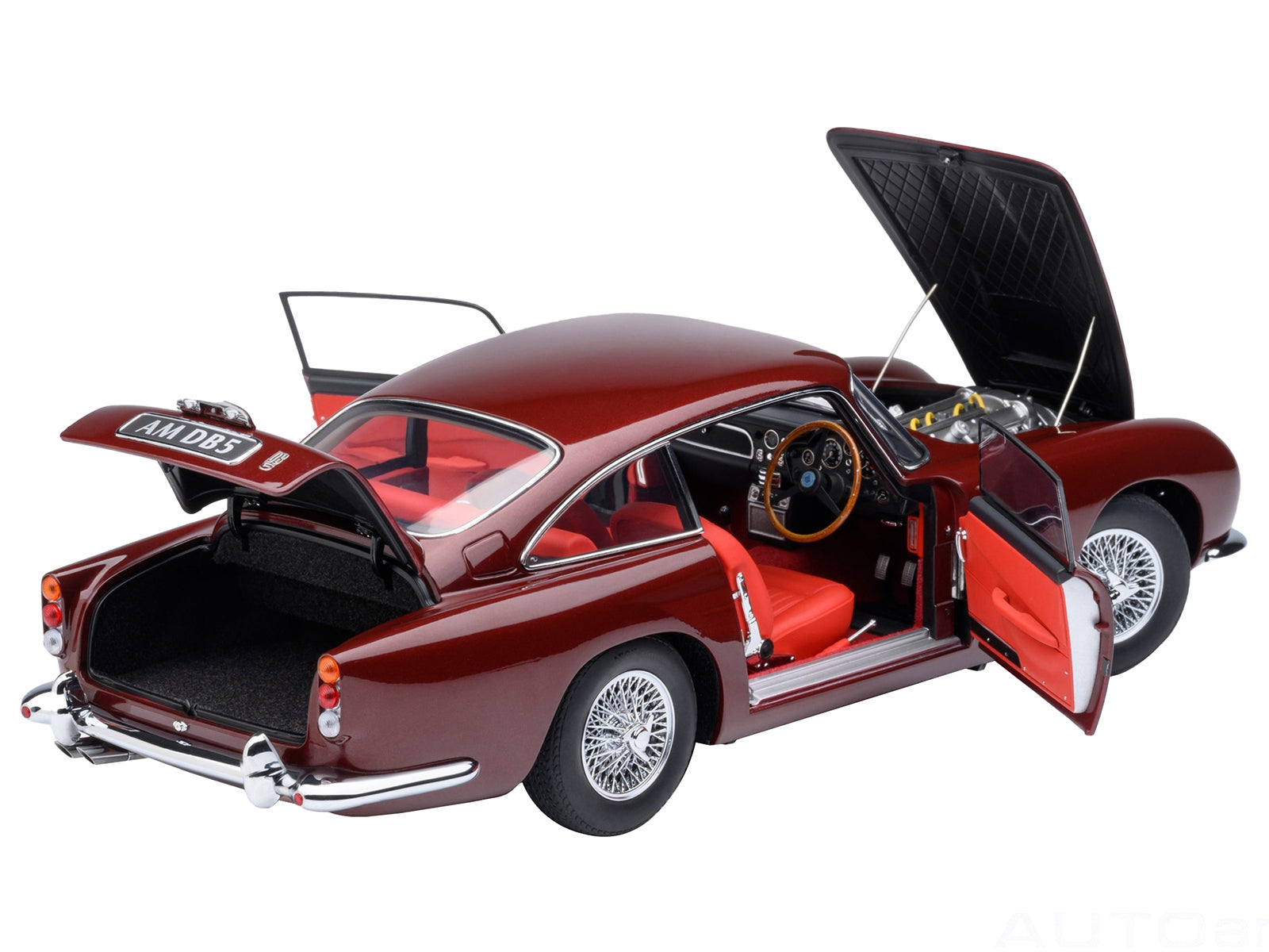 Aston Martin DB5 RHD model car in Dubonnet Rosso Red metallic by Autoart, detailed 1/18 scale collectible vehicle.