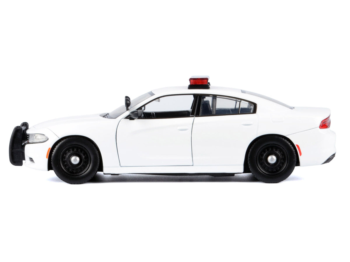 2023 Dodge Charger Pursuit police car diecast model by Motormax, unmarked white with flashing light bar, front and rear lights, and sounds.