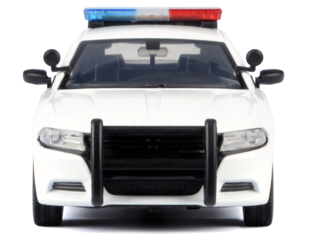 2023 Dodge Charger Pursuit police car diecast model by Motormax, unmarked white with flashing light bar and front and rear lights.
