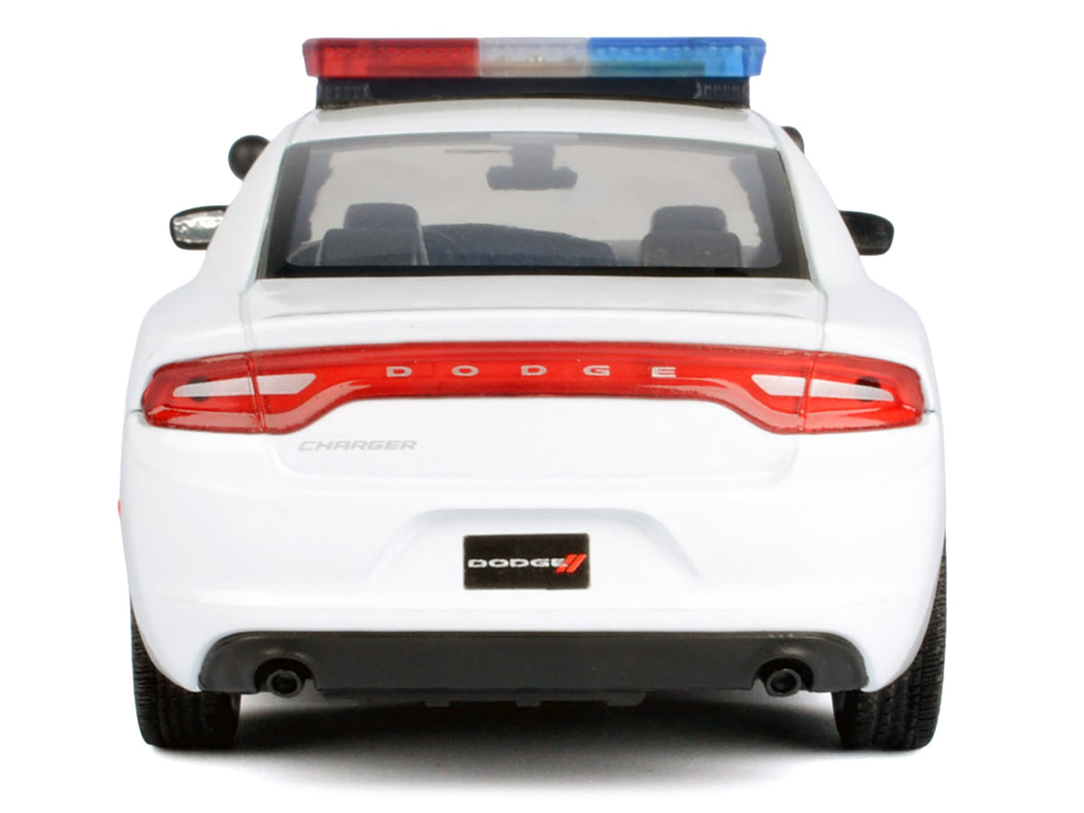 2023 Dodge Charger Pursuit police car diecast model by Motormax, white unmarked with flashing light bar, front and rear lights, and sounds.