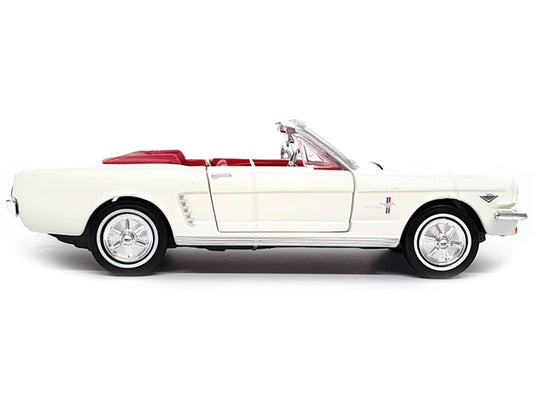 White 1964 1/2 Ford Mustang convertible diecast model by Motormax from James Bond "Goldfinger" movie series, featuring red interior.
