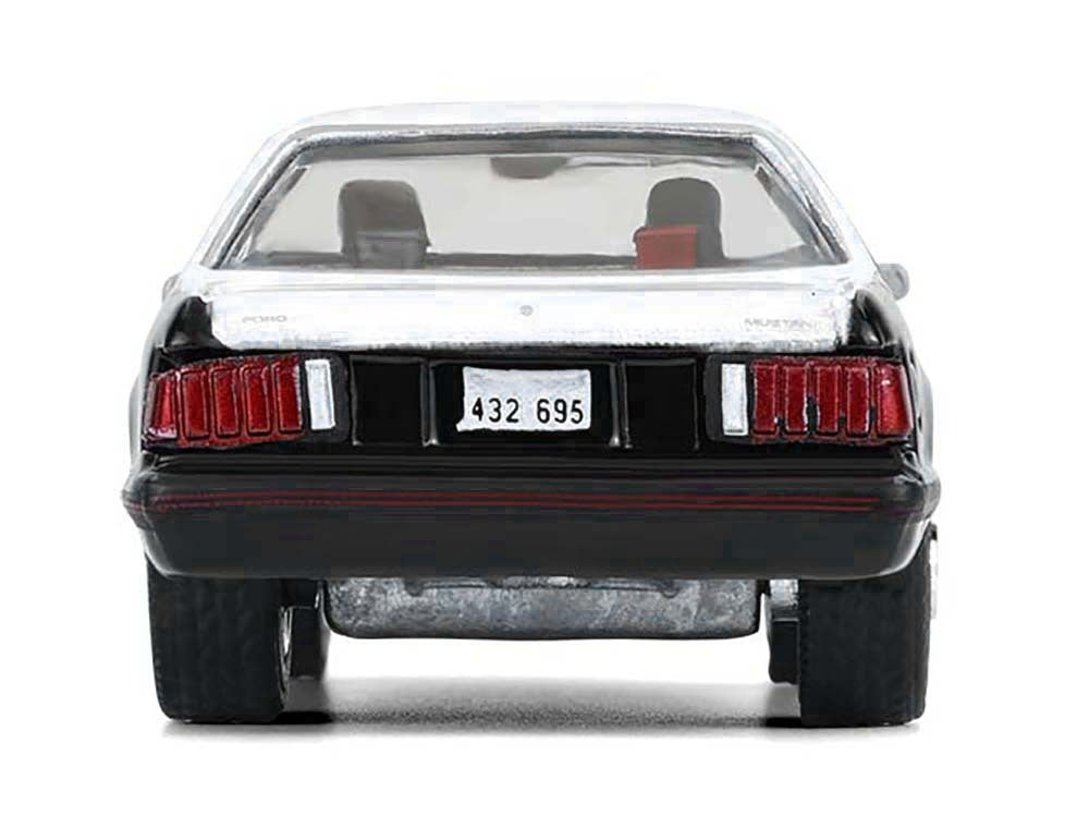 1982 Ford Mustang SSP diecast model car by Greenlight, black with white hood and top, detailed Texas Highway Patrol replica.