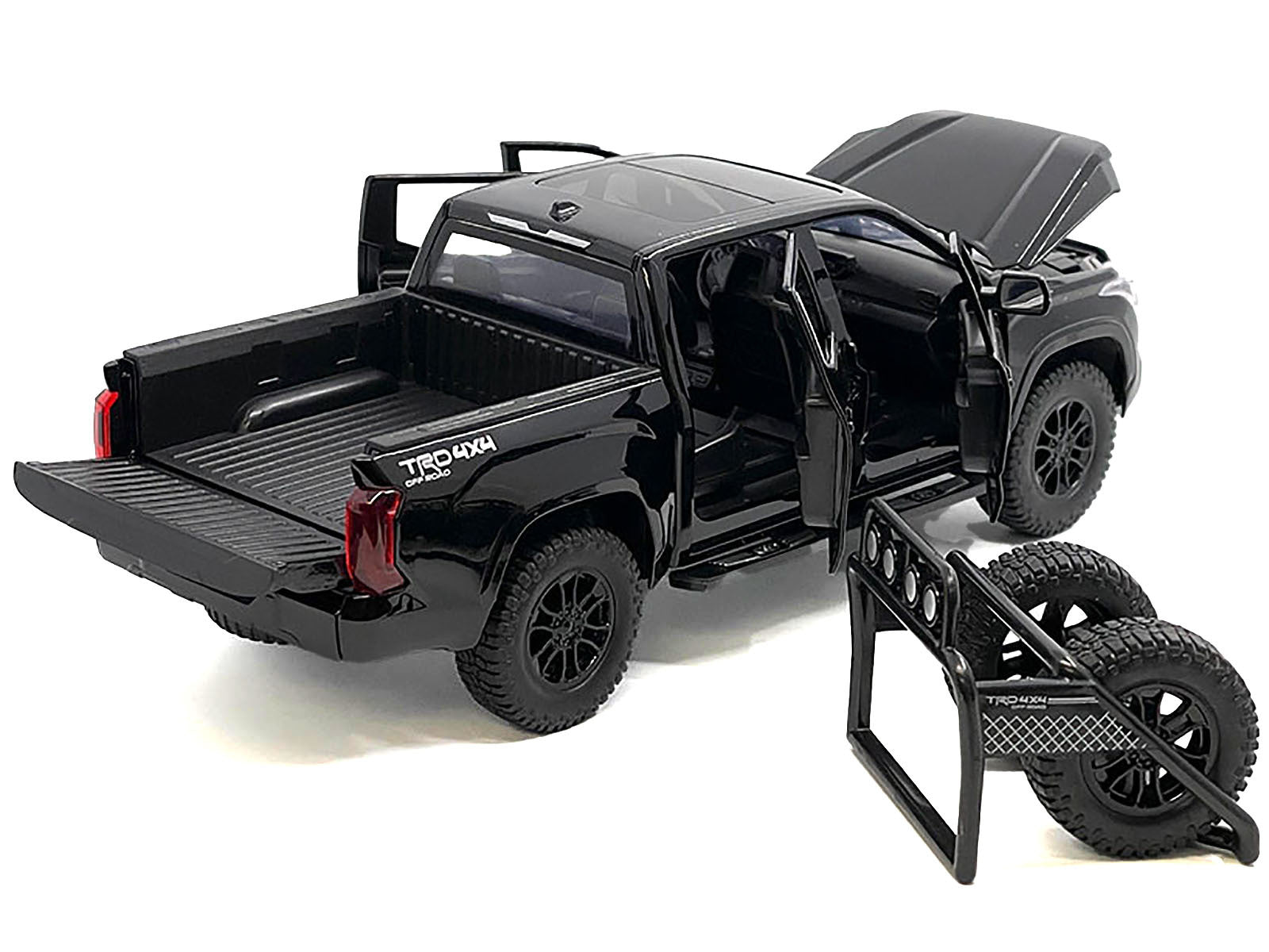 Black 2023 Toyota Tundra TRD 4x4 diecast model truck with sunroof and wheel rack, detailed 1/24 scale collectible car.