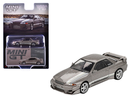 Gray metallic Nissan Skyline GT-R R32 mini diecast model by Mini GT, Veilside Combat C-I edition, right-hand drive, 1/64 scale.