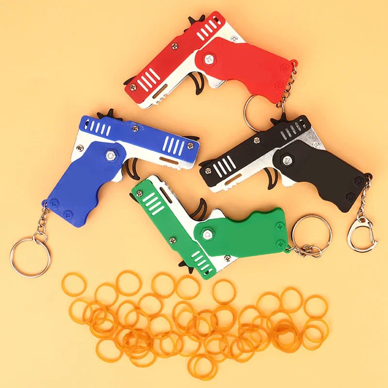 1x Mini Keychain Gun Rubber Band Toy Shooting Pistol Alloy Kid Outdoor Activities Party Game Birthday Gift for Children Creative