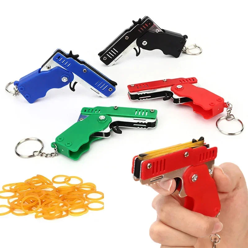 1x Mini Keychain Gun Rubber Band Toy Shooting Pistol Alloy Kid Outdoor Activities Party Game Birthday Gift for Children Creative