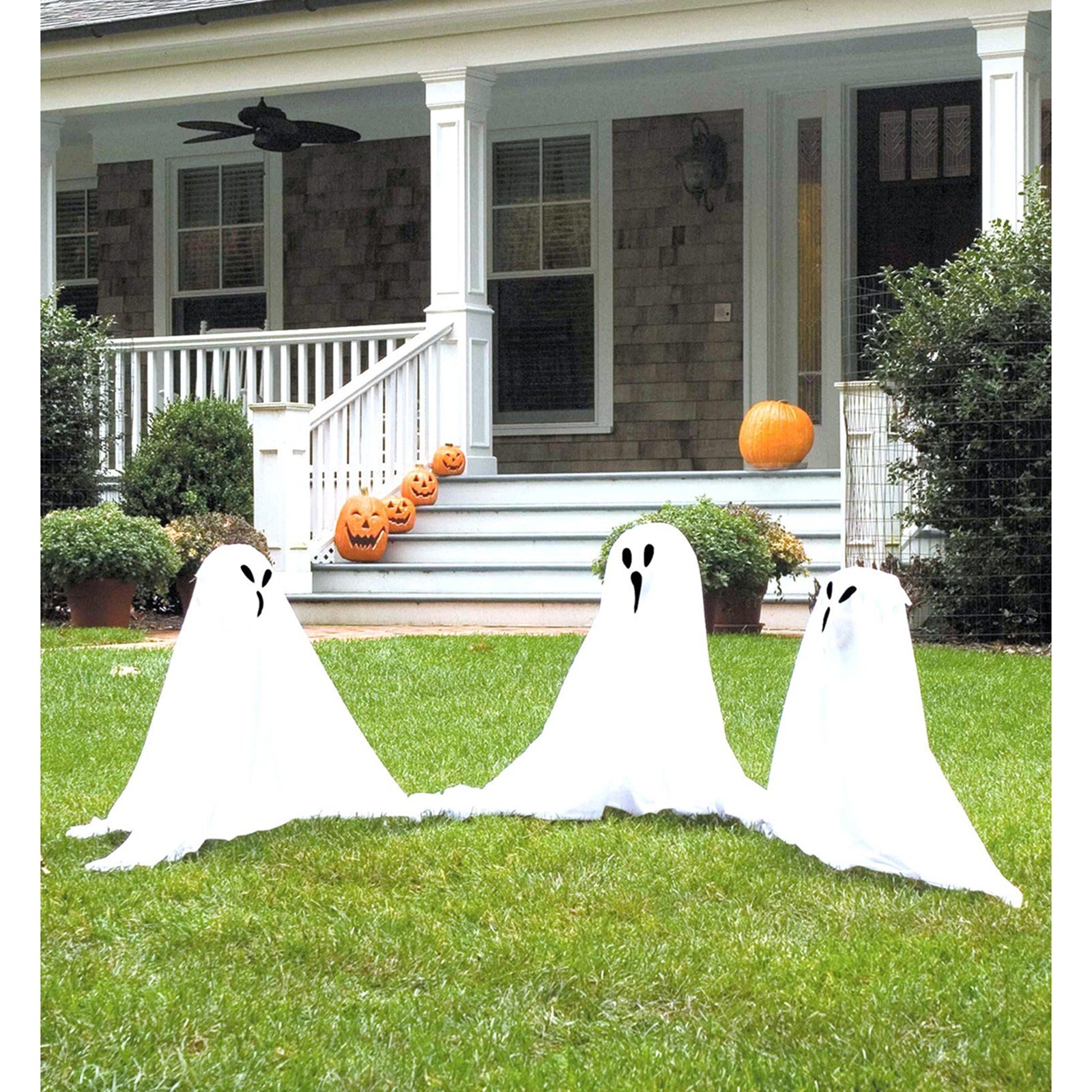 Small ghostly group lawn ornament mask by Buy Seasons, featuring spooky Halloween-themed ghost masks for outdoor decoration.