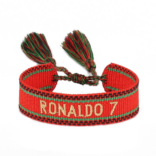 Braided football World Cup bracelet with star charms, hand-tied tassels, and American Smart branding, for soccer fans.