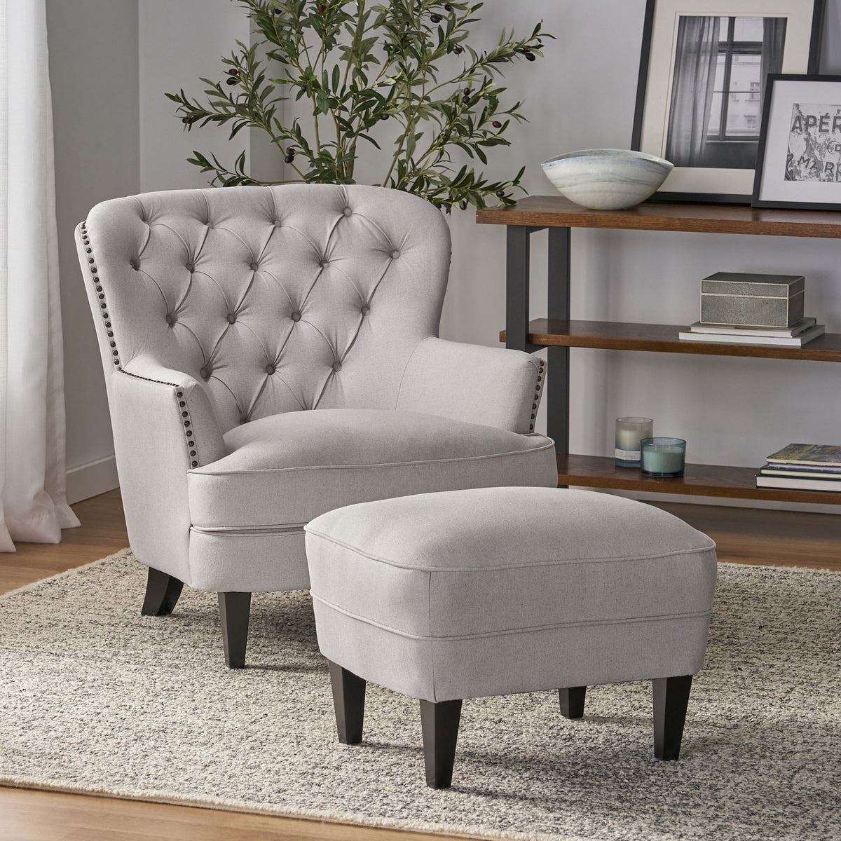 Modern light grey fabric club chair and ottoman set with cushioned arms, stylish and comfortable for living room seating.