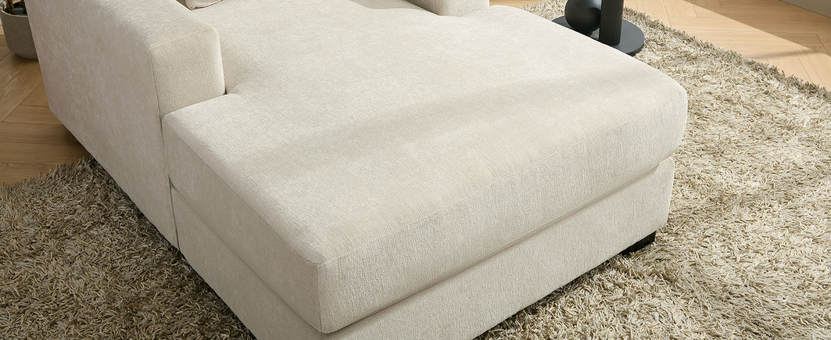 Cream oversized chaise lounge sofa with pillows, built-in charge station and cup holders, in modern chenille fabric.