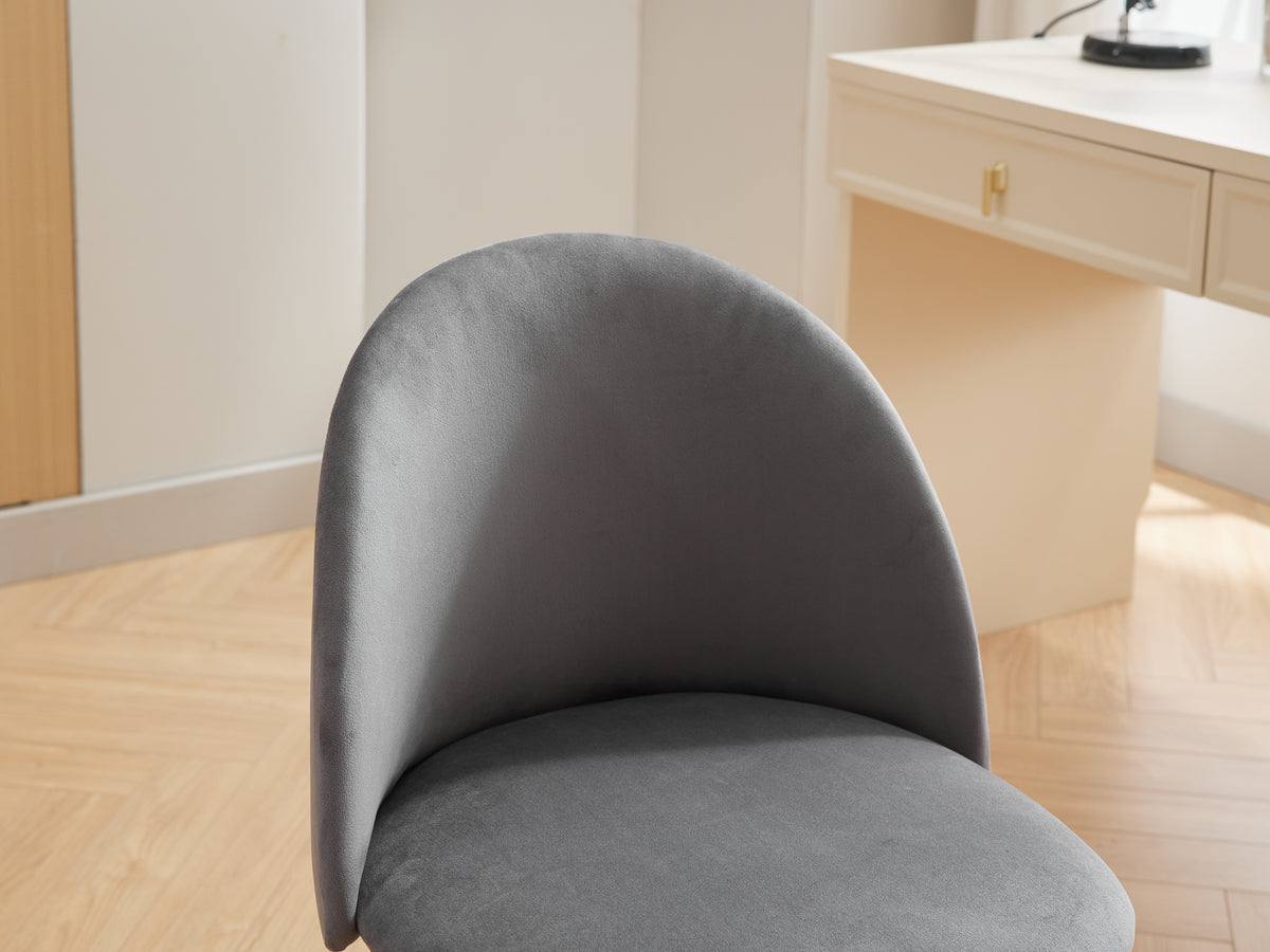 Black velvet fabric office chair with cushioned seat, mid back, adjustable height, wheels, and black legs for comfortable computer work.