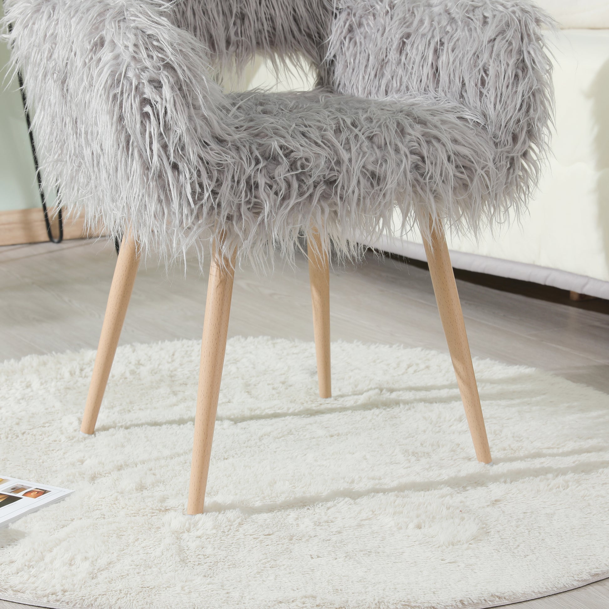 Grey faux fur upholstered makeup and dining chair with beech metal legs, modern and stylish for living or dressing rooms.