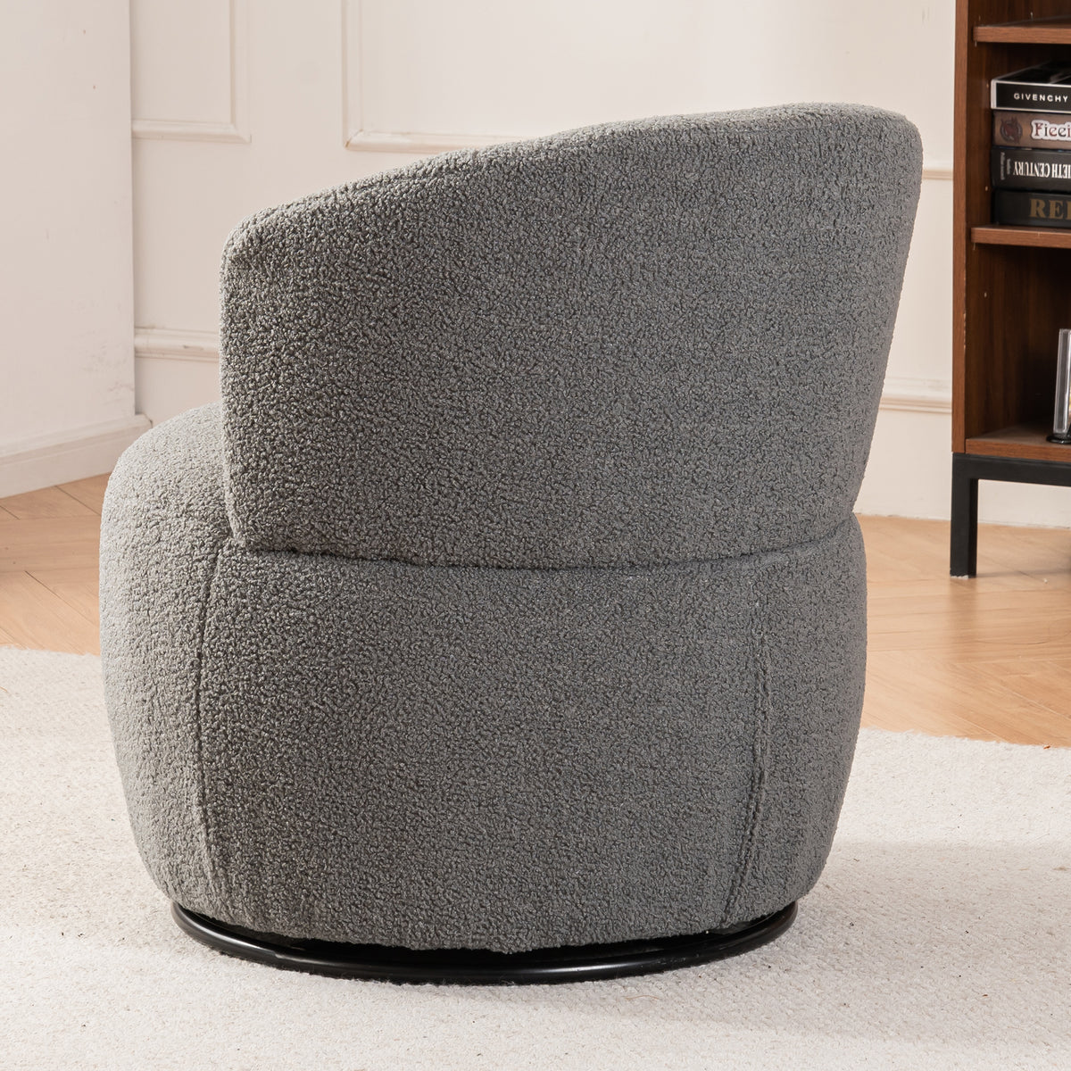 Grey plush swivel accent chair with round arms and metal base, perfect for contemporary living room elegance.