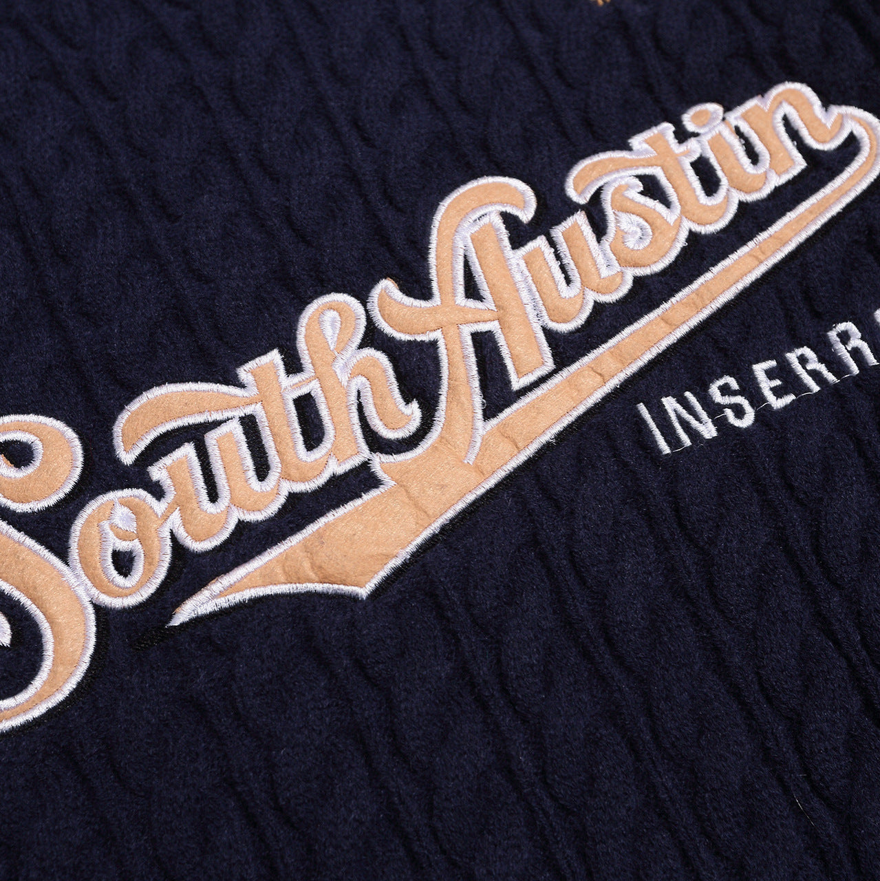 American Smart V-neck casual sweater with letter embroidery, soft knit fabric, and relaxed fit in neutral color.