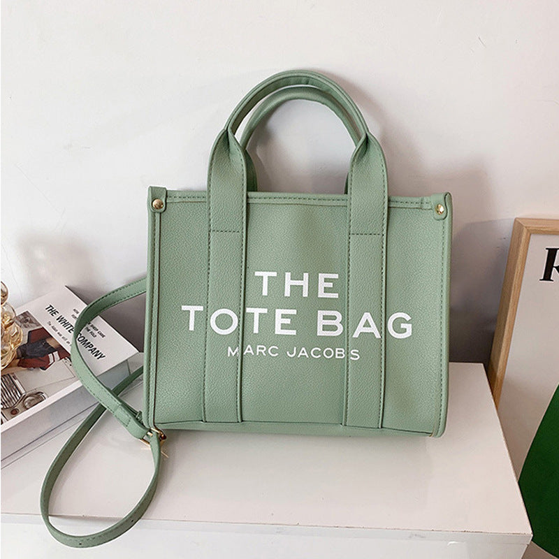 Small women's trendy tote and crossbody bag by American Smart, featuring a stylish single shoulder design and compact size.