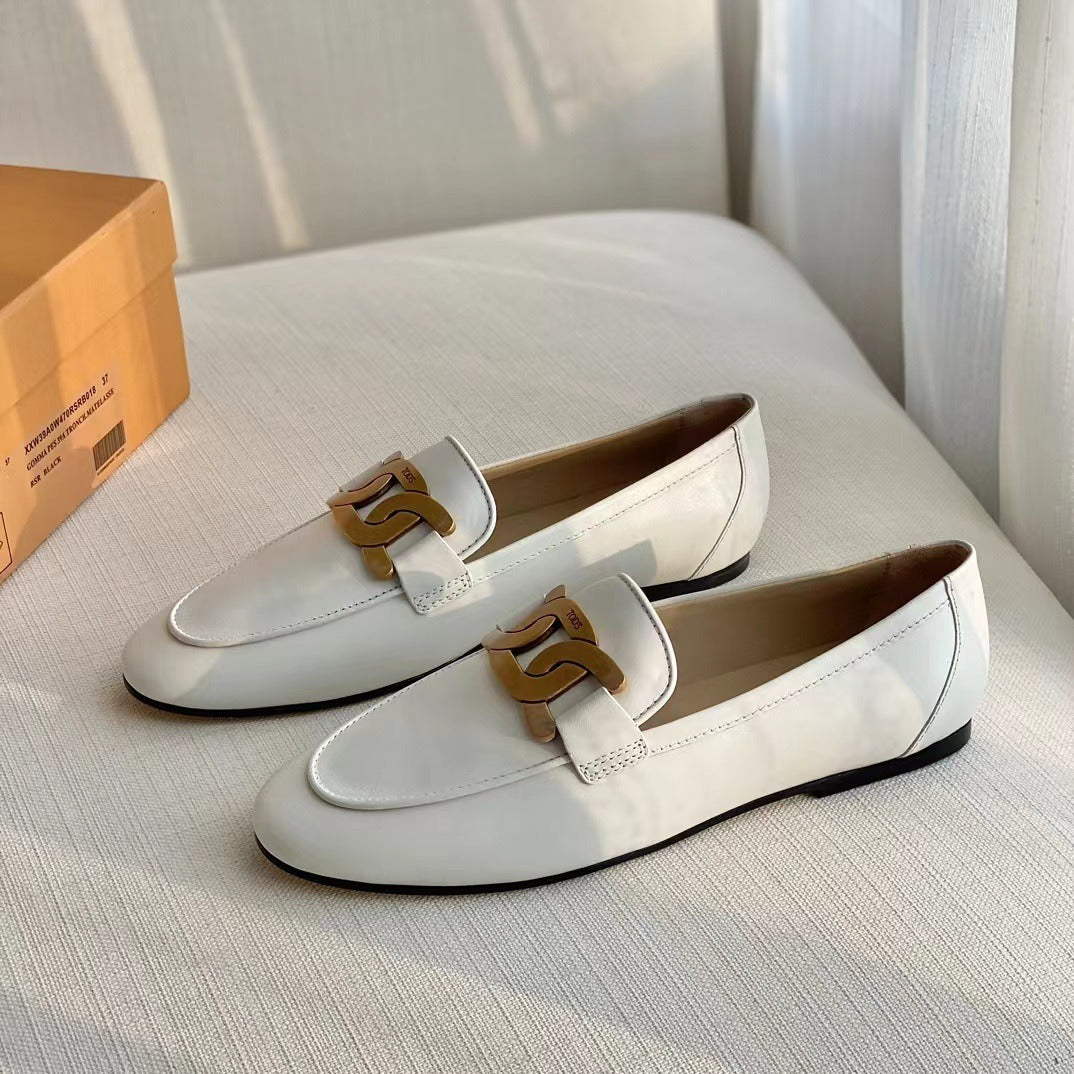White and black leather oxford shoes with metal buckle, flat heel, British retro style for women’s office and career wear.