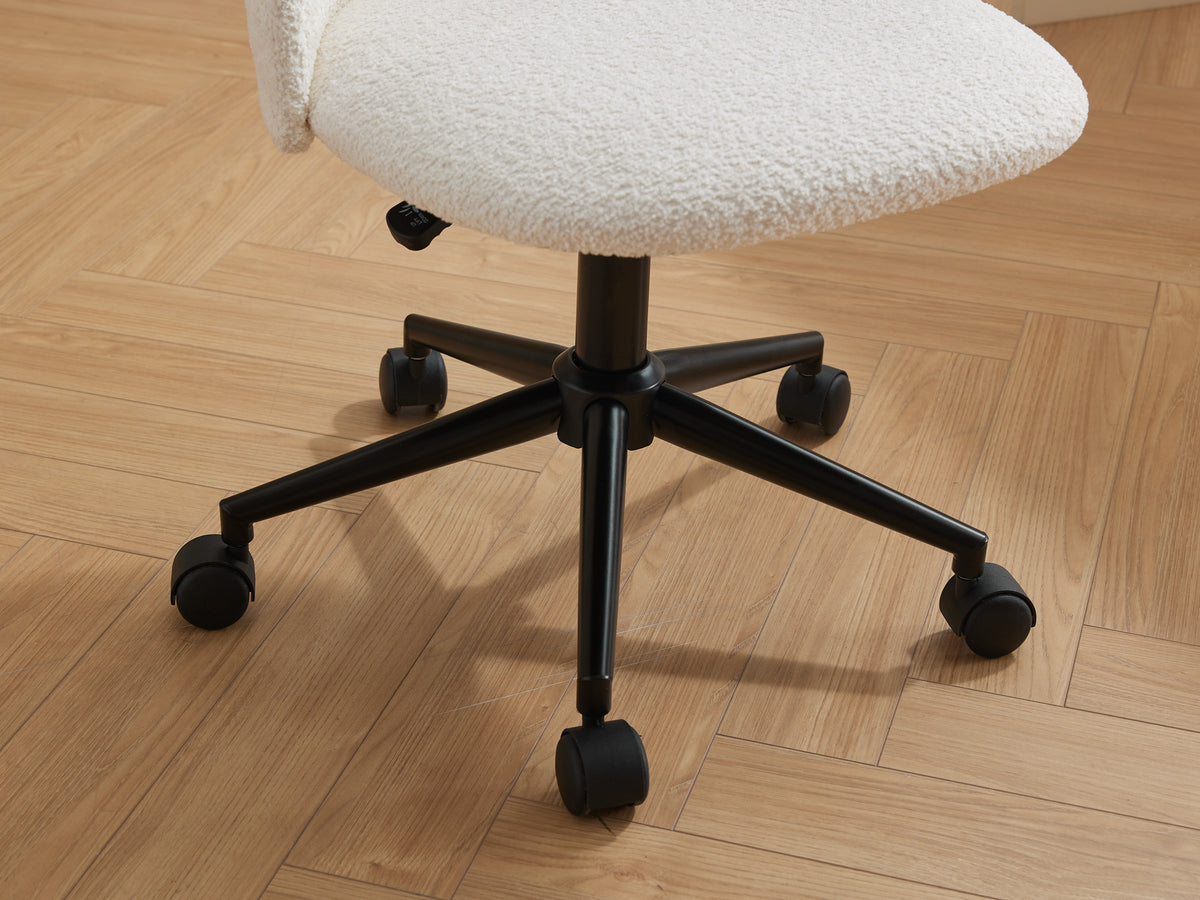Black velvet fabric office chair with cushioned seat, white frame, black legs, wheels, and adjustable height for comfort.