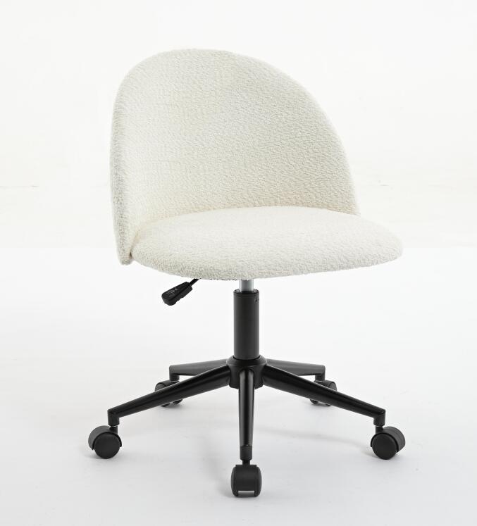 Black velvet fabric office chair with white cushioning, adjustable height, rotating base, wheels, and black legs for a modern workspace.