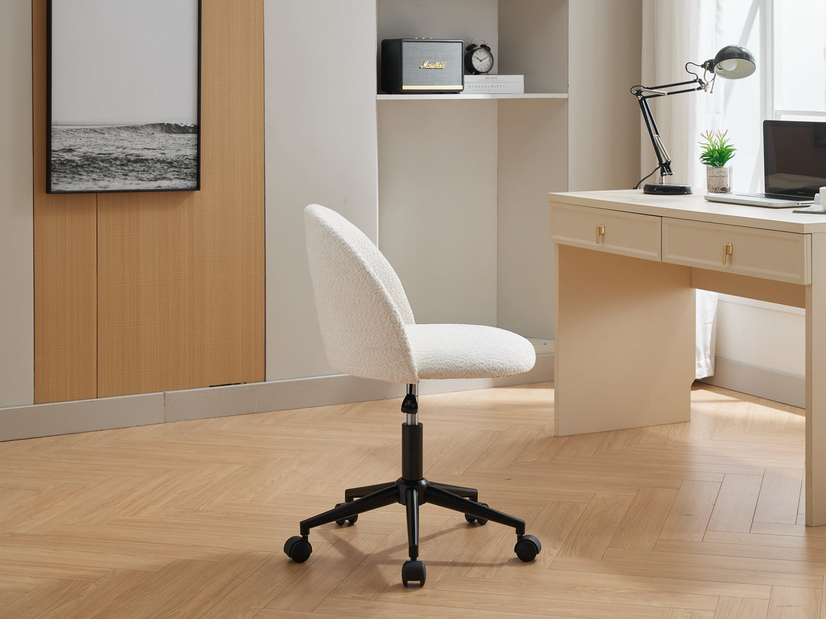 Black velvet fabric office chair with white cushion, mid-back design, adjustable height, rotating, wheeled computer chair with black legs.