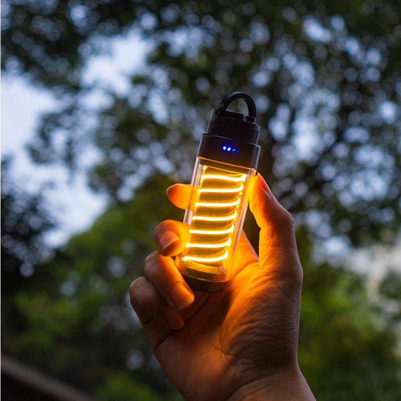 American Smart EP outdoor camping light with tripod stand, portable flashlight, and marquee tent atmosphere lighting setup.
