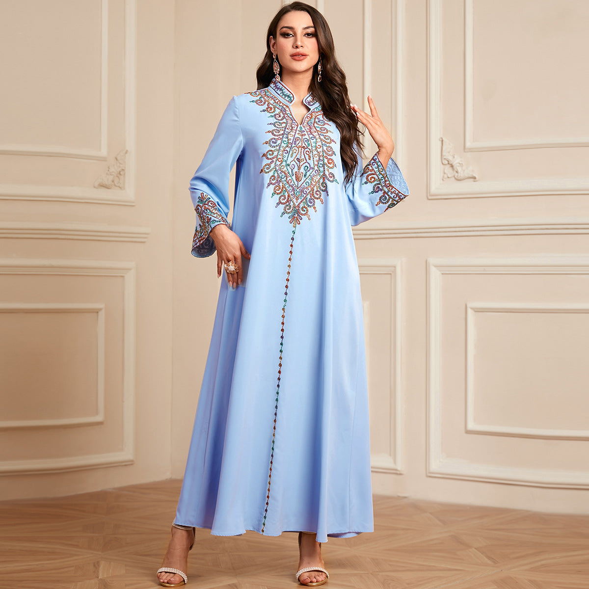 Embroidered Middle Eastern long Muslim robe with V-neck, traditional Arabic Dubai Jalabiya, worn by a woman.