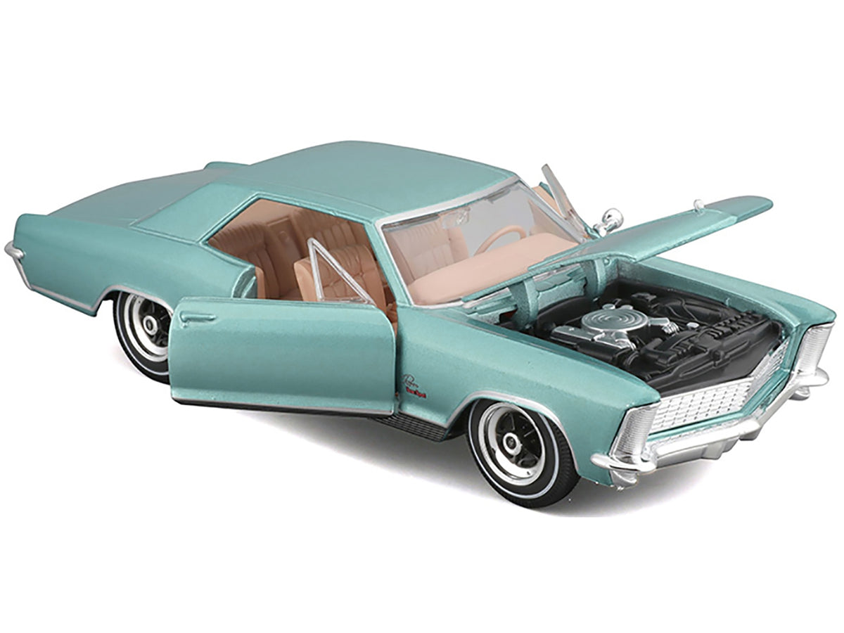 Light blue metallic 1965 Buick Riviera Gran Sport diecast model car by Maisto, detailed Series 1/26 scale collectible vehicle.