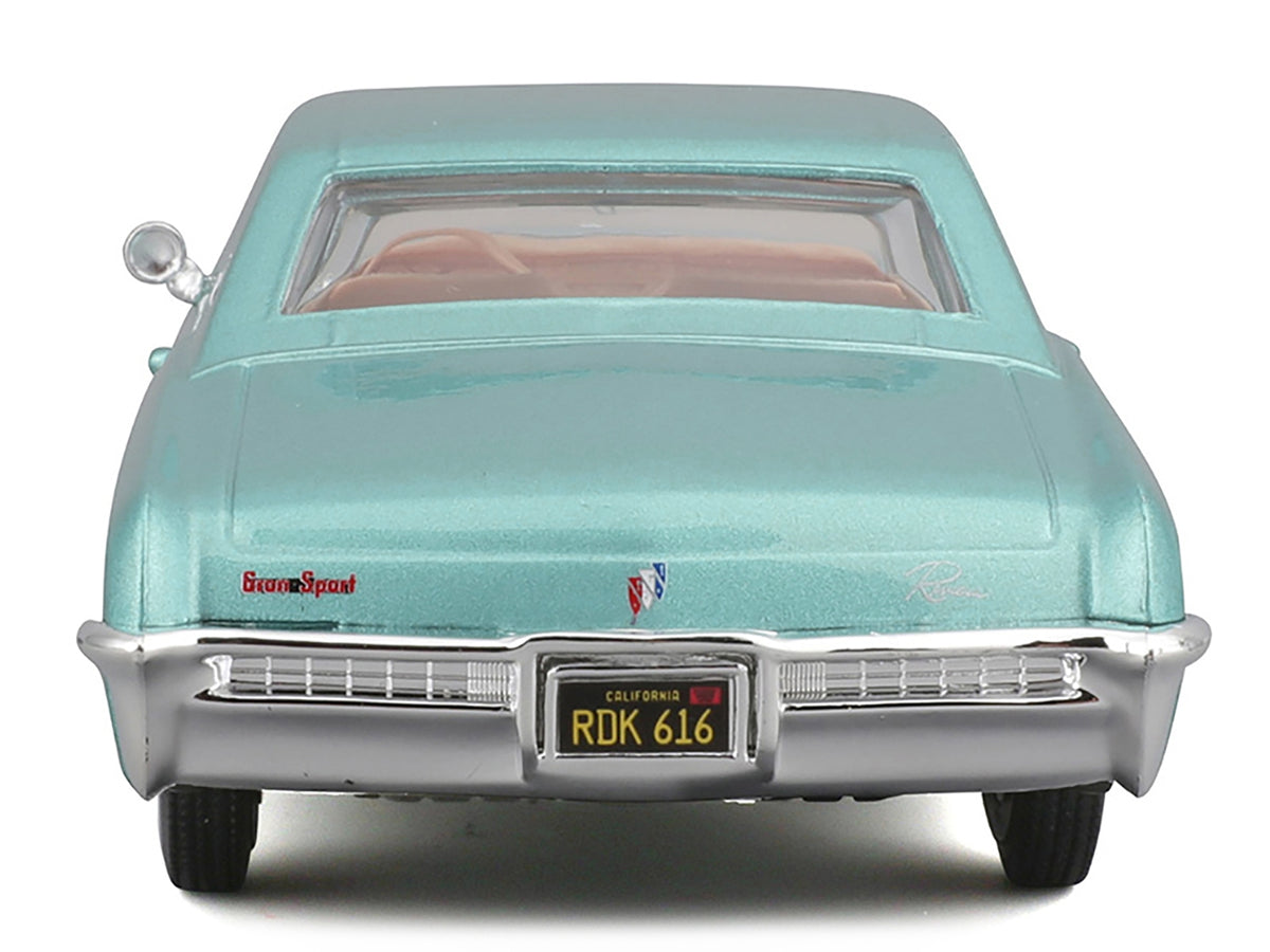 Light blue metallic 1965 Buick Riviera Gran Sport diecast model car by Maisto, detailed collectible from American Smart WB.