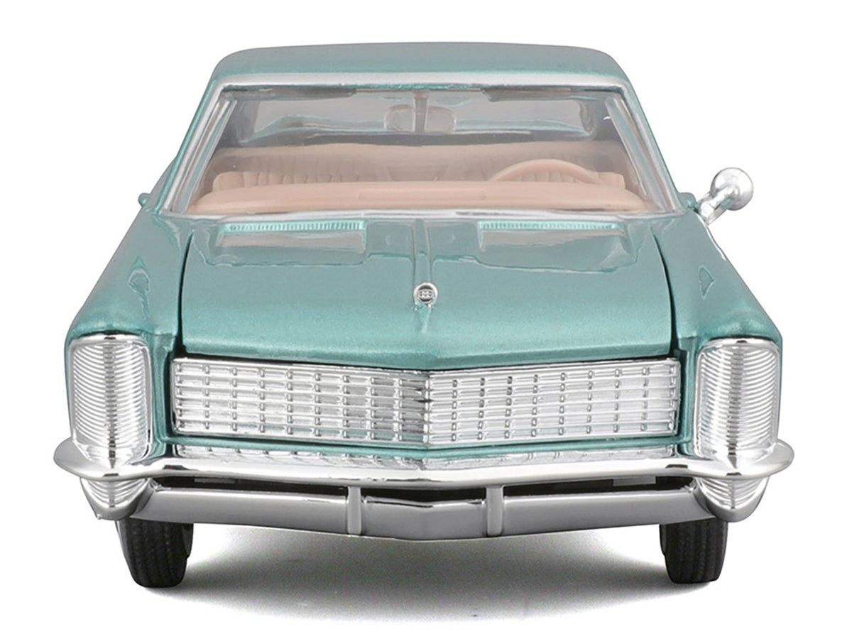 Light blue metallic 1965 Buick Riviera Gran Sport diecast model car by Maisto, detailed scale replica from American Smart WB series.