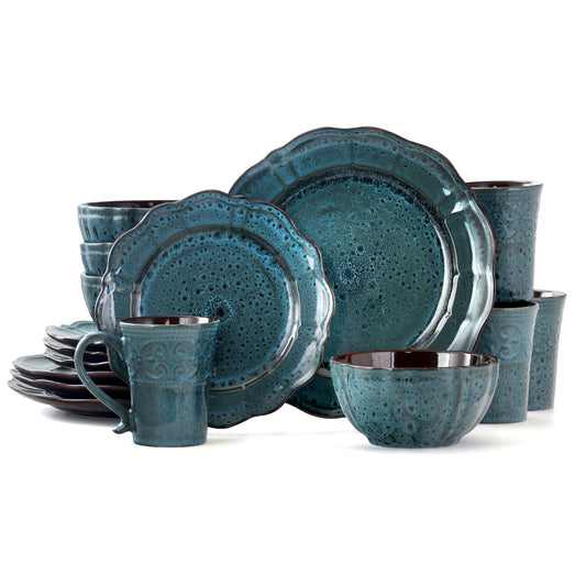 Elama Lavish Blue 16-piece dinnerware set by American Smart with plates, bowls, and mugs for four people.