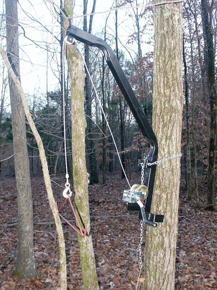 American Smart WB Kwik Hoist game hoist with chain, used for hunting gear and scouting camera setup.