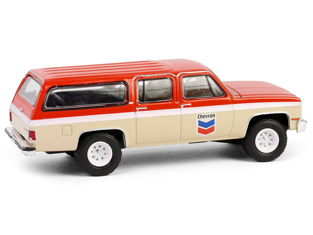 1988 GMC Suburban Sierra Classic C10 diecast model car in orange and beige with white stripes, part of Greenlight's Chevron Special Edition series.