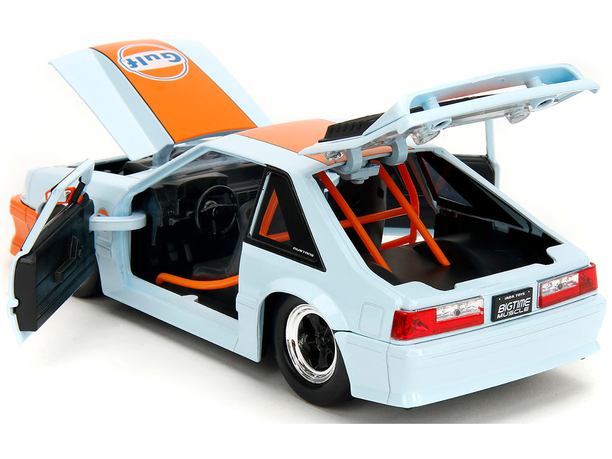 Light blue 1989 Ford Mustang GT "Gulf Oil" diecast model car with orange stripe, from Jada Bigtime Muscle series.