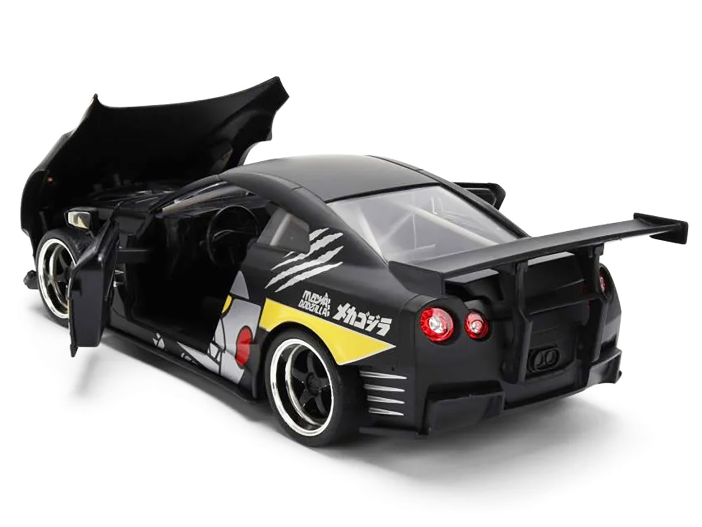 2009 Nissan GT-R (R35) Ben Sopra matte black diecast model car with "Mechagodzilla" graphics, part of Hollywood Rides series by Jada