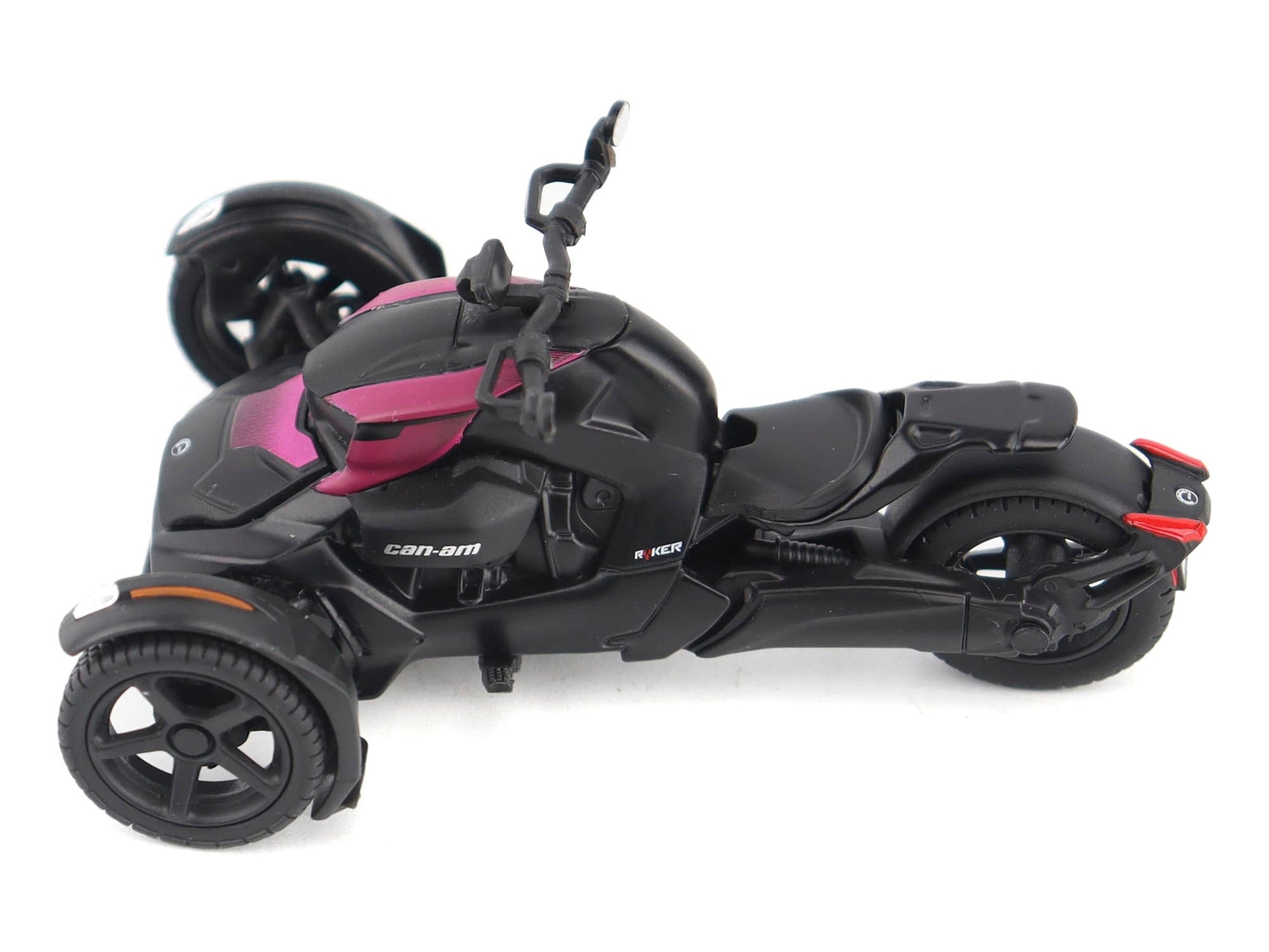 Pink and black Can-Am Ryker 3-wheel motorcycle diecast model by BRP, with driver figure, detailed miniature collectible.