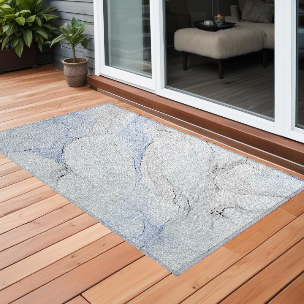 Ivory, blue, and gray abstract washable outdoor area rug with non-slip backing by American Smart, suitable for indoor and outdoor use.