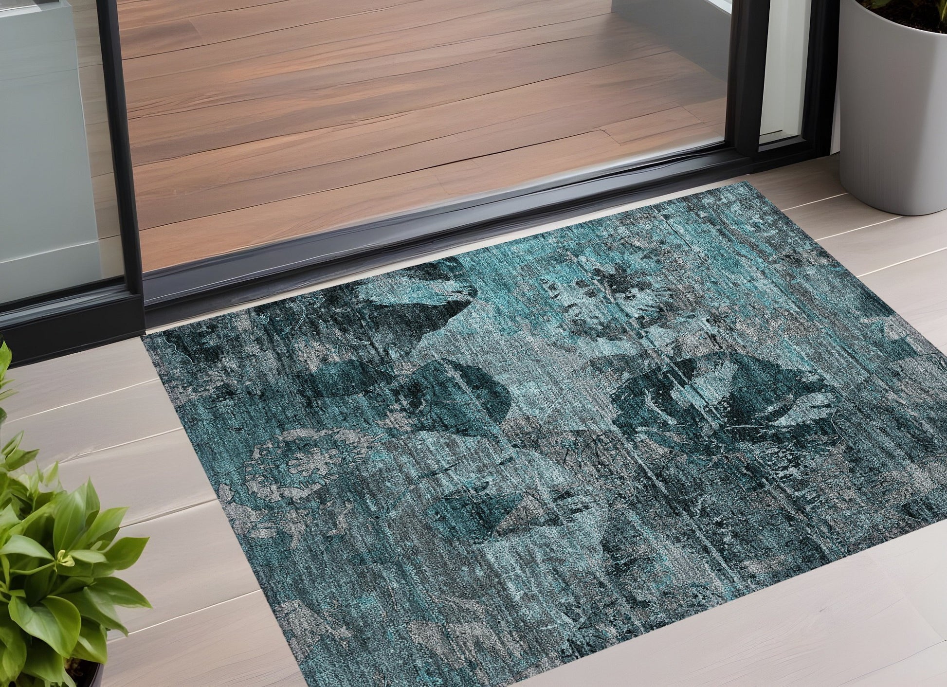 American Smart outdoor rug, 3x5 ft teal and gray floral washable non-skid indoor outdoor area rug on a patio.