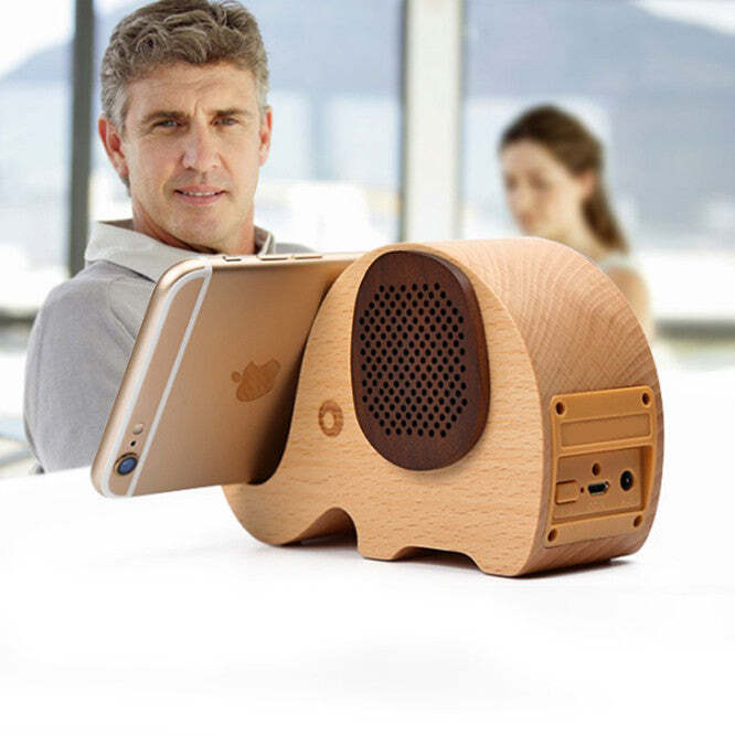 American Smart WOODSY GOODSY 2-in-1 Bluetooth speaker and cell phone stand, wooden design with speaker grille and phone cradle visible