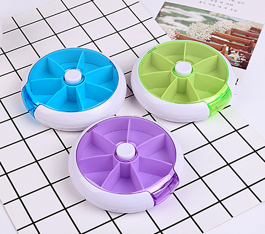 American Smart portable rotating medicine box with seven compartments, round storage bottles for organized medication storage.