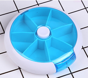 American Smart portable round rotating medicine box with 7 compartments, designed for organized storage of pills and supplements.