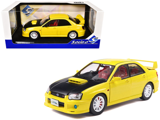 Yellow 2003 Subaru Impreza WRX STI RHD diecast model car by Solido, featuring a carbon fiber hood, detailed 1/18 scale replica.